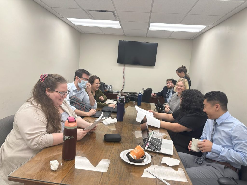 Students around the table from L to R: Claire Foster, True Shields, Lindsay Waters, (supervising attorneys James in rear w/ supervisor Emily Genzlinger (’20)), Rachel Castillo, Sully Bautista, & Ryan Balaoing